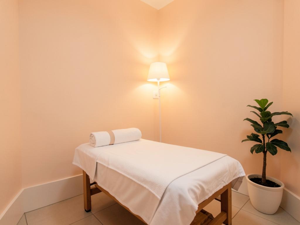 Esthetician treatment suite in Clayton County, Georgia with soft peach walls and a facial bed
